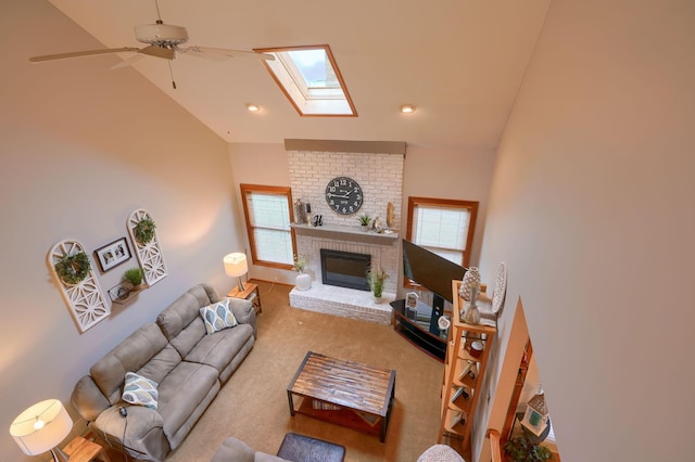 living room featuring a wealth of natural light, vaulted ceiling with skylight, and a fireplace