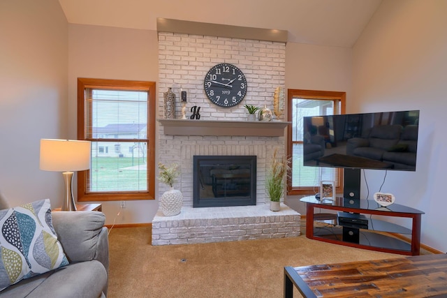 living room featuring vaulted ceiling, carpet flooring, and a fireplace