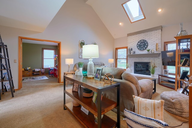 carpeted living room featuring high vaulted ceiling, a fireplace, and a skylight