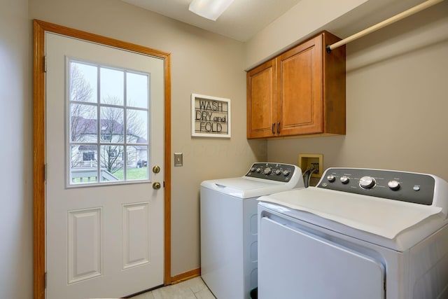 laundry area featuring cabinets and washing machine and clothes dryer