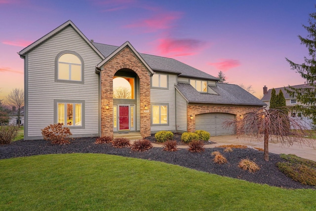 view of front facade featuring a garage and a lawn