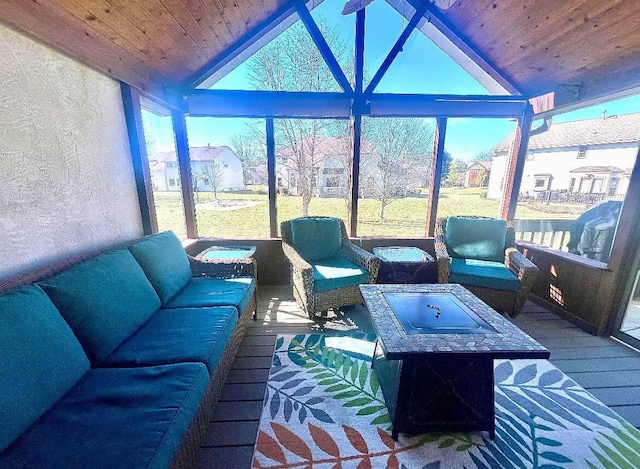 sunroom featuring lofted ceiling and wood ceiling