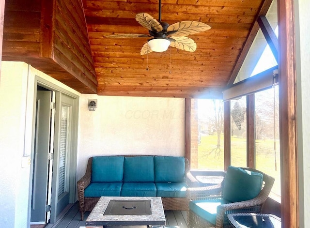 sunroom / solarium featuring vaulted ceiling, wooden ceiling, and ceiling fan