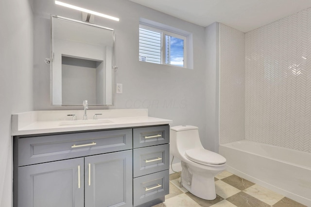 full bathroom with vanity, tiled shower / bath, and toilet