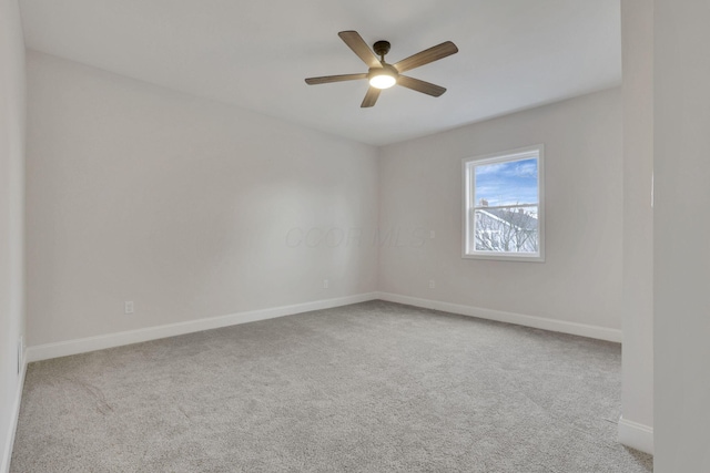 empty room featuring light carpet and ceiling fan