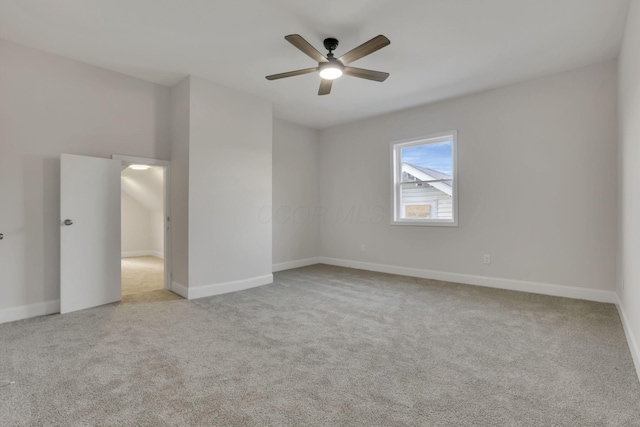 carpeted spare room with ceiling fan