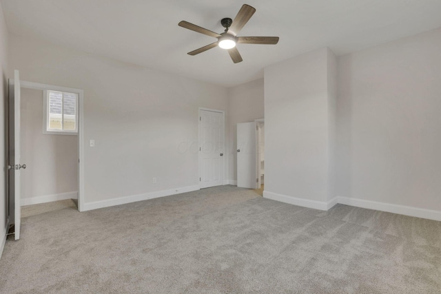 unfurnished room with light colored carpet and ceiling fan