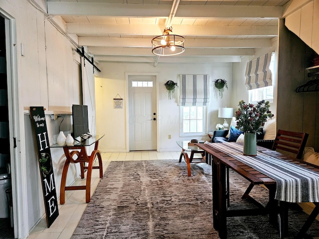 interior space with beamed ceiling, a barn door, and wood ceiling