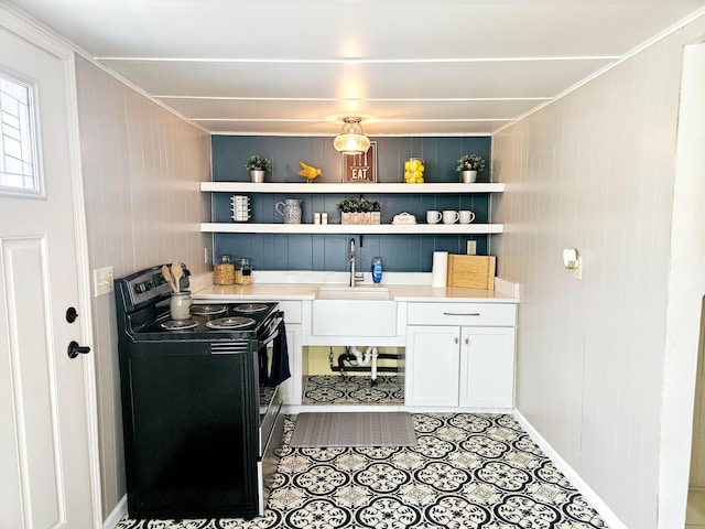 kitchen featuring white cabinets, ornamental molding, sink, and electric range