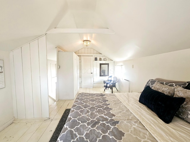 bedroom featuring lofted ceiling and light hardwood / wood-style floors