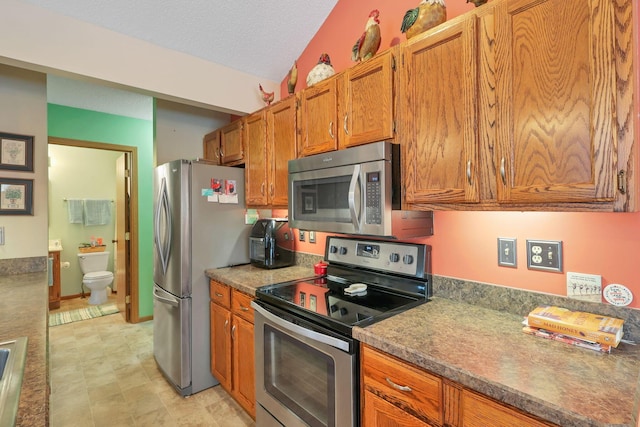 kitchen featuring stainless steel appliances and a textured ceiling