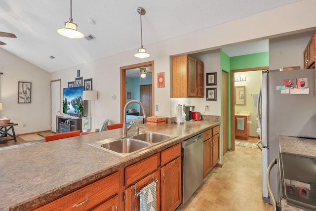 kitchen featuring appliances with stainless steel finishes, sink, ceiling fan, and decorative light fixtures