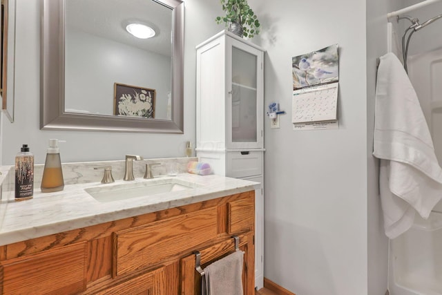 bathroom with vanity and a shower