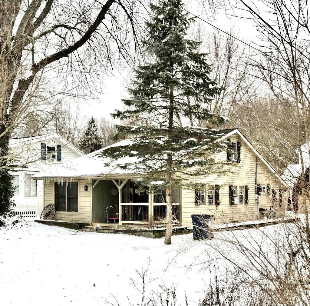 view of snow covered back of property