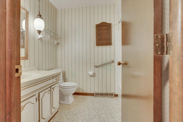 bathroom featuring vanity and toilet