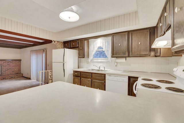 kitchen featuring sink, kitchen peninsula, white appliances, and decorative backsplash