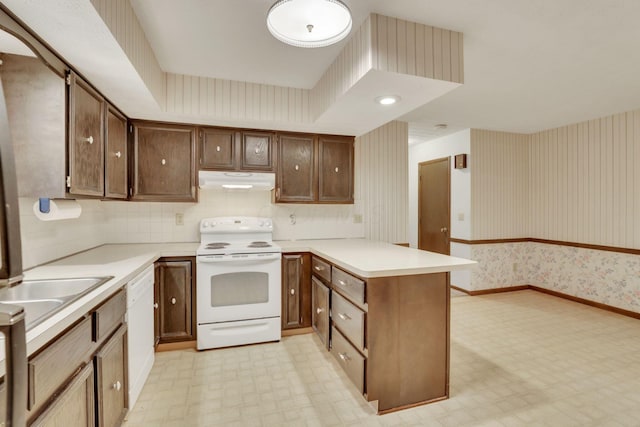 kitchen featuring sink, white appliances, and kitchen peninsula