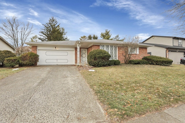 single story home featuring a garage and a front lawn