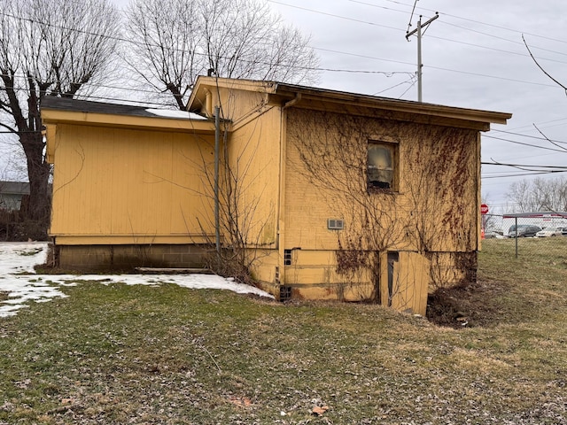 view of home's exterior with a yard