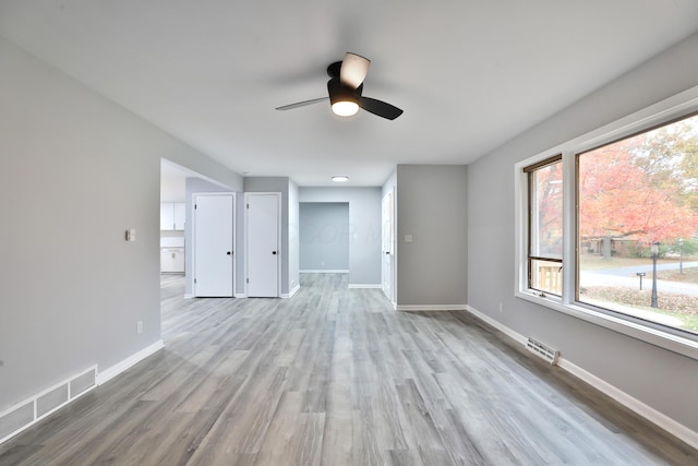 unfurnished living room featuring light hardwood / wood-style flooring and ceiling fan