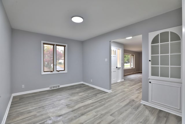 spare room featuring light wood-type flooring