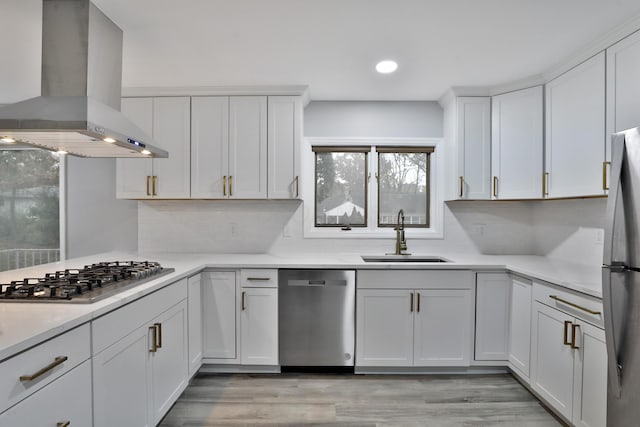 kitchen with sink, white cabinetry, tasteful backsplash, appliances with stainless steel finishes, and island exhaust hood