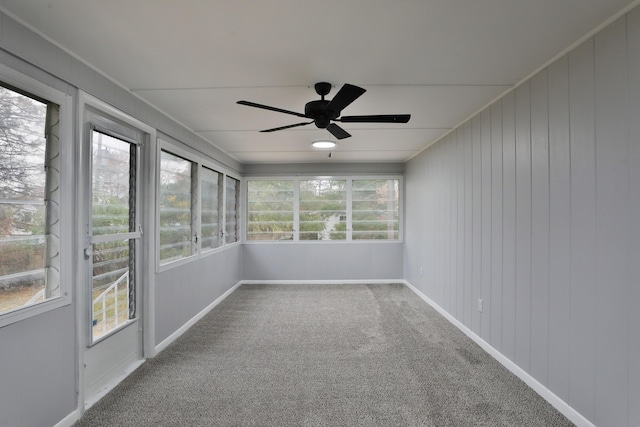 unfurnished sunroom with ceiling fan