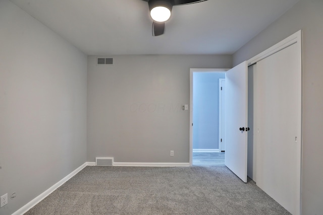 carpeted empty room with ceiling fan