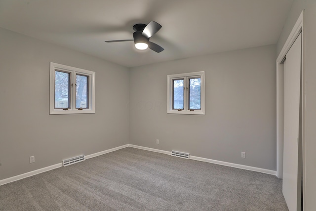 unfurnished bedroom featuring carpet flooring, ceiling fan, and a closet