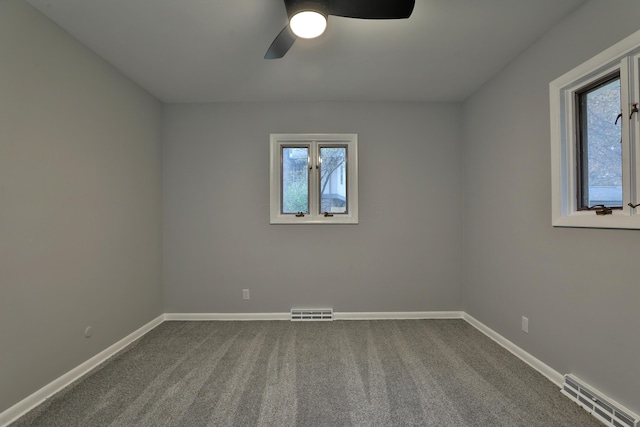 carpeted spare room featuring ceiling fan