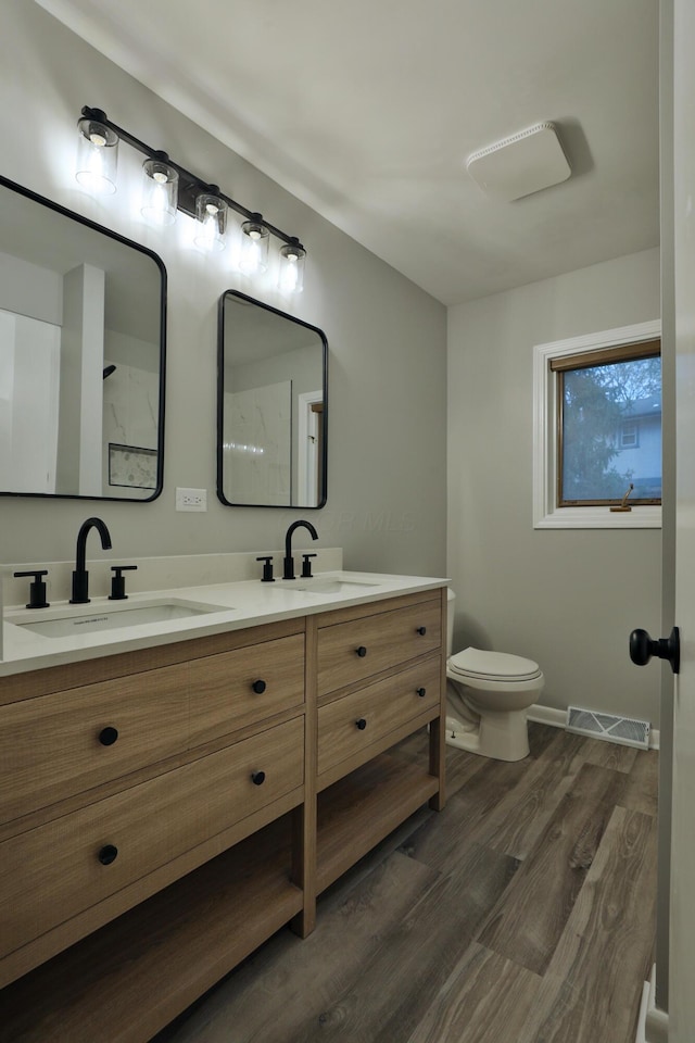 bathroom featuring hardwood / wood-style flooring, vanity, and toilet