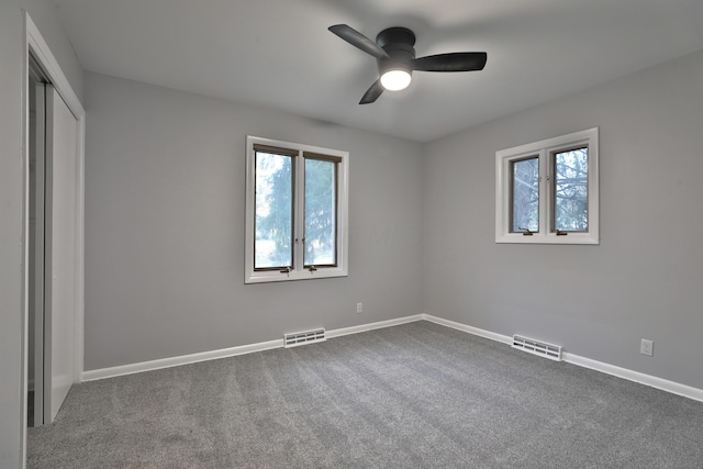 unfurnished bedroom with ceiling fan, a closet, and carpet