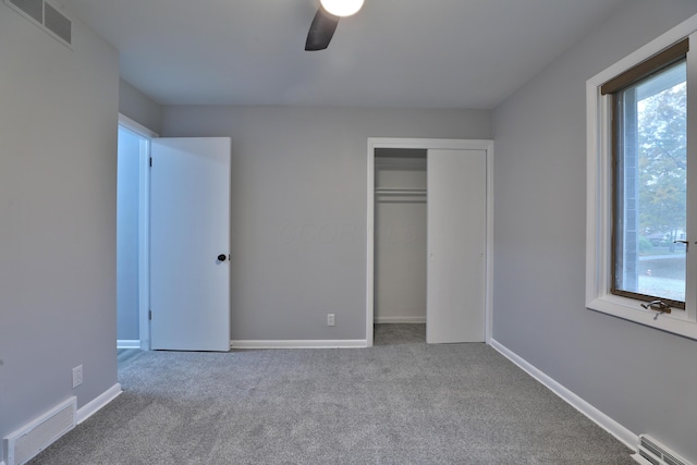 unfurnished bedroom with light colored carpet, a closet, and ceiling fan