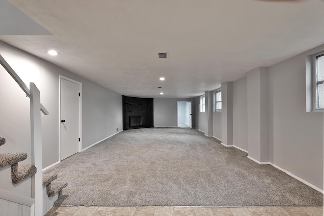 basement featuring light carpet