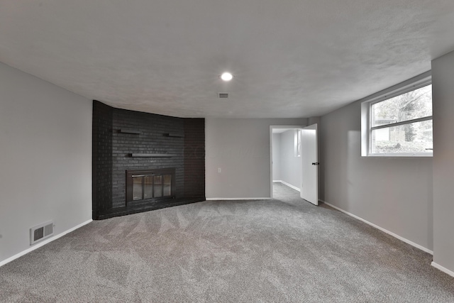 unfurnished living room featuring carpet floors and a fireplace