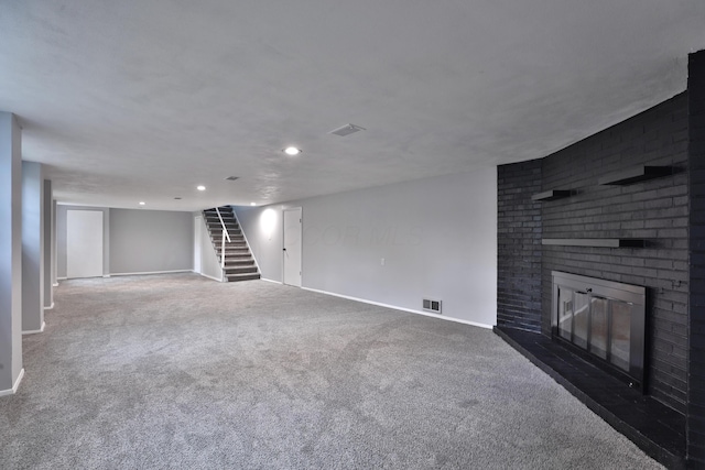 unfurnished living room with a brick fireplace and dark carpet