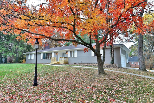 single story home with a garage and a front lawn