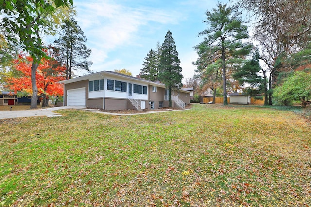 view of front of property with a garage and a front yard