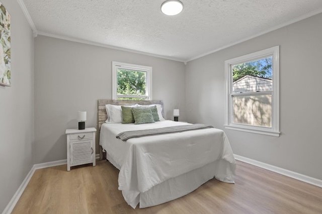 bedroom featuring hardwood / wood-style flooring, ornamental molding, and multiple windows