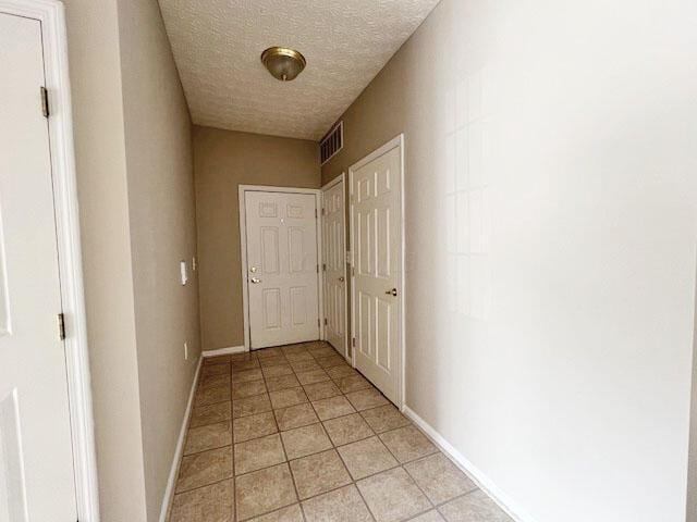 6155 Pelican Pointe Unit 103, Columbus, OH 43231 - hall with light tile patterned floors, a textured ceiling, and baseboards
