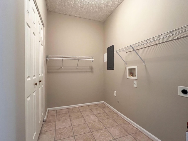 6155 Pelican Pointe Unit 103, Columbus, OH 43231 - laundry area with hookup for an electric dryer, washer hookup, electric panel, baseboards, and light tile patterned flooring