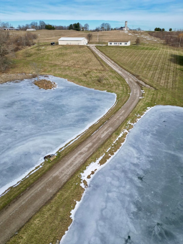 drone / aerial view featuring a rural view and a water view