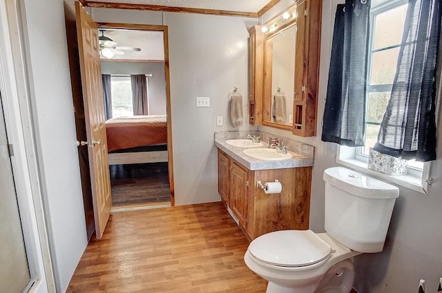 bathroom featuring toilet, crown molding, vanity, hardwood / wood-style flooring, and ceiling fan