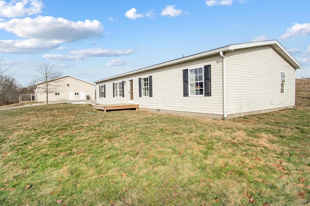 rear view of property with a lawn and a deck