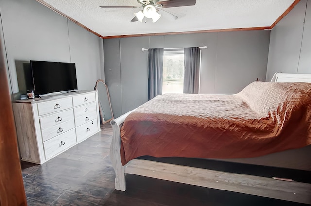 bedroom featuring ceiling fan, ornamental molding, dark hardwood / wood-style flooring, and a textured ceiling