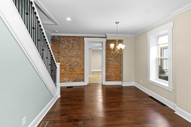 unfurnished dining area with ornamental molding, dark hardwood / wood-style flooring, and a chandelier