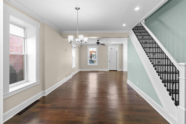 unfurnished dining area with crown molding, dark hardwood / wood-style floors, and ceiling fan with notable chandelier