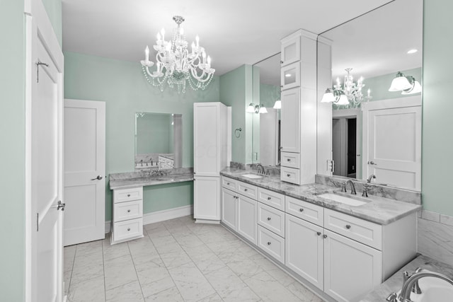 bathroom featuring vanity, a bathing tub, and a chandelier