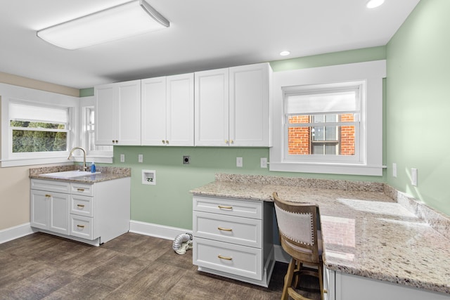 clothes washing area with sink, dark hardwood / wood-style flooring, cabinets, washer hookup, and hookup for an electric dryer