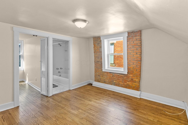 interior space featuring hardwood / wood-style flooring and lofted ceiling